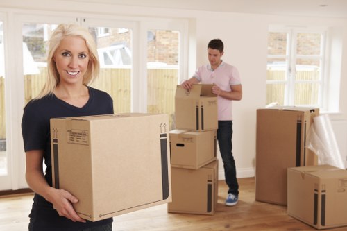 Moving team handling removals in Hammersmith with furniture and boxes