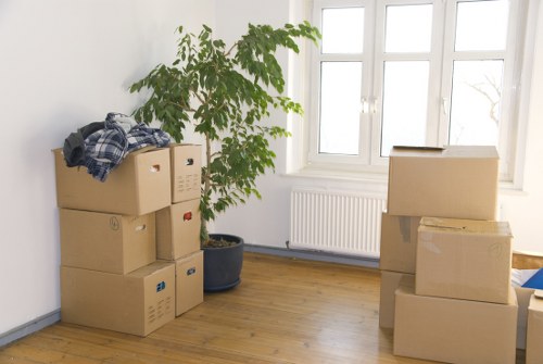 Packed boxes and moving trolley prepared for a Hammersmith apartment removal