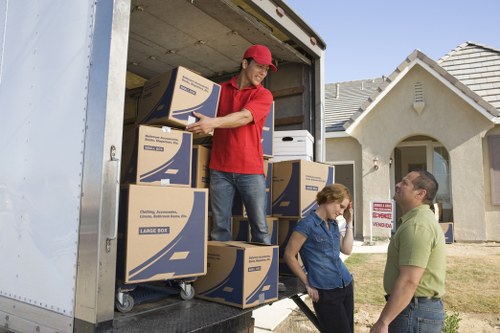 Professional movers handling furniture in a Hammersmith property