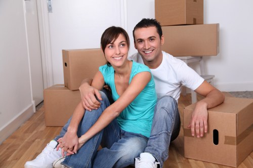 Furniture and boxes being loaded into a moving van in West London